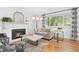 Bright living room with a white-painted brick fireplace and large window at 8390 E Davies Pl, Centennial, CO 80112