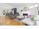 Spacious living room with open floor plan, view of dining area, and white-painted brick fireplace at 8390 E Davies Pl, Centennial, CO 80112