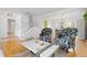 Open-concept living room with hardwood floors and a view to the dining area and the stairway at 8390 E Davies Pl, Centennial, CO 80112