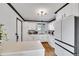 Bright kitchen featuring white cabinets, a marble countertop, and hardwood floors at 1060 W 133Rd Cir # C, Denver, CO 80234