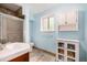 Bright bathroom boasts a modern vanity, sleek glass shower, and ample storage in a clean and contemporary design at 10009 Dodge Dr, Northglenn, CO 80260