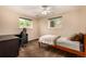 Bright bedroom with neutral walls, two windows, and a comfortable bed offers a relaxing and inviting atmosphere at 10009 Dodge Dr, Northglenn, CO 80260