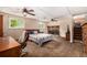 The spacious bedroom features dual ceiling fans, a fireplace, and comfortable furnishings, offering a relaxing retreat at 10009 Dodge Dr, Northglenn, CO 80260