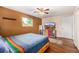 Primary bedroom with hardwood flooring, ceiling fan, tv and neutral walls at 10009 Dodge Dr, Northglenn, CO 80260