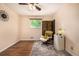 Bedroom featuring hardwood flooring, soft natural light, a cozy armchair and unique decor at 10009 Dodge Dr, Northglenn, CO 80260