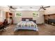 A spacious bedroom features dual ceiling fans, large windows, and comfortable furnishings, perfect for relaxation at 10009 Dodge Dr, Northglenn, CO 80260