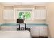 Bedroom with hardwood flooring, built in desk, and a beautiful view to the outside at 10009 Dodge Dr, Northglenn, CO 80260