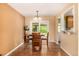 Bright dining room with hardwood floors, large window with natural light, and a table with four chairs at 10009 Dodge Dr, Northglenn, CO 80260