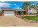 Charming single-Gathering home featuring a brick facade, well-kept lawn, mature trees, and a two car garage at 10009 Dodge Dr, Northglenn, CO 80260
