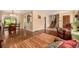 Spacious living room featuring hardwood floors, access to the dining area, and comfortable seating at 10009 Dodge Dr, Northglenn, CO 80260