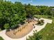 Aerial view showcasing a fun playground with swings, slides, and green surroundings at 10009 Dodge Dr, Northglenn, CO 80260
