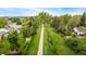 Scenic aerial view of the neighborhood walking trail, surrounded by lush greenery and mature trees at 10009 Dodge Dr, Northglenn, CO 80260
