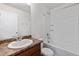 Bathroom featuring a shower-tub combo, a toilet, and a vanity with a mirror, perfect for daily routines at 5383 Andes St, Denver, CO 80249