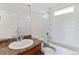 Bathroom featuring a shower-tub combo, a toilet, and a vanity with a mirror, designed for functionality and style at 5383 Andes St, Denver, CO 80249