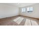 Spacious bedroom with ample natural light, carpeting, creating a warm and welcoming space at 5383 Andes St, Denver, CO 80249