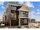 Two-story home featuring a balcony, brown siding, and a well-maintained front yard at 5383 Andes St, Denver, CO 80249