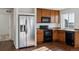 Bright kitchen featuring wood cabinets, dark countertops, and stainless steel appliances at 5383 Andes St, Denver, CO 80249