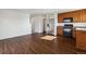 Open floor plan showcasing the living room and kitchen with stainless steel refrigerator at 5383 Andes St, Denver, CO 80249