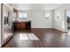 Open floor plan showcasing the living room and kitchen with stainless steel refrigerator at 5383 Andes St, Denver, CO 80249