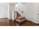 View of a carpeted staircase leading upstairs with wood flooring at the base, and a window bringing in natural light at 5383 Andes St, Denver, CO 80249