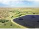 Aerial view of a community, showcasing a golf course and a lake at 5009 Mt Osage St, Frederick, CO 80504