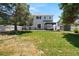 Wide shot of the backyard featuring a patio, shed, lush green lawn, and privacy fence at 5009 Mt Osage St, Frederick, CO 80504