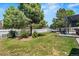 Beautiful backyard with lush green grass, mature trees, and a cozy patio area with outdoor furniture at 5009 Mt Osage St, Frederick, CO 80504