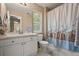 Bathroom with shower/tub combo, white vanity, mirror, and toilet at 5009 Mt Osage St, Frederick, CO 80504