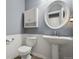 Powder room featuring beadboard paneling, toilet, pedestal sink with framed mirror and cabinet at 5009 Mt Osage St, Frederick, CO 80504