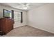 This bedroom features a dresser, window and neutral carpet with white walls at 5009 Mt Osage St, Frederick, CO 80504