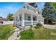 Charming two-story home with a inviting front porch, complemented by manicured landscaping at 5009 Mt Osage St, Frederick, CO 80504