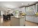 Bright kitchen featuring a center island, granite countertops, and easy access to the dining area at 5009 Mt Osage St, Frederick, CO 80504