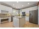 Well-equipped kitchen with granite countertops, white cabinetry, and stainless steel appliances at 5009 Mt Osage St, Frederick, CO 80504