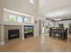 Open-concept living area with hardwood floors, a fireplace, and seamless flow to the dining area at 5009 Mt Osage St, Frederick, CO 80504