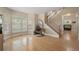 Bright living room with hardwood floors, large windows, and an elegant staircase at 5009 Mt Osage St, Frederick, CO 80504