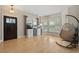 Cozy living room with hardwood floors, a stylish hanging chair, and abundant natural light at 5009 Mt Osage St, Frederick, CO 80504