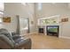 Bright living room boasts a fireplace, large windows, hardwood floors, and comfortable seating at 5009 Mt Osage St, Frederick, CO 80504