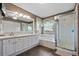 Main bathroom with shower, large tub, dual vanity, and large mirror at 5009 Mt Osage St, Frederick, CO 80504