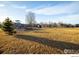 Community playground with swings and play structure in a large grassy field on a sunny day at 5009 Mt Osage St, Frederick, CO 80504