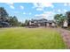 Well-manicured backyard featuring lush green grass and mature trees, perfect for relaxation and outdoor activities at 10114 Meade Ct, Westminster, CO 80031