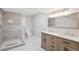 Beautiful bathroom features a stylish vanity with double sinks, a tiled shower and modern fixtures at 10114 Meade Ct, Westminster, CO 80031