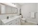 Bathroom with gray walls, white marble countertop, modern light fixtures, and a patterned floor at 10114 Meade Ct, Westminster, CO 80031