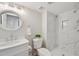 Updated bathroom with marble countertops, sink, toilet, and a walk-in shower at 10114 Meade Ct, Westminster, CO 80031