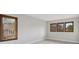 Bedroom showing warm wood trim surrounding the windows, gray walls, and neutral carpeting at 10114 Meade Ct, Westminster, CO 80031