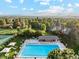 Aerial shot features a sparkling community pool, tennis courts and lush landscaping for outdoor recreation at 10114 Meade Ct, Westminster, CO 80031