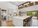 Bright kitchen boasts white cabinets, a large marble island, and wood flooring at 10114 Meade Ct, Westminster, CO 80031