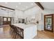 Bright kitchen features an oversized island with seating, stainless appliances, and wood beams at 10114 Meade Ct, Westminster, CO 80031