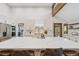 Open kitchen features an oversized island with seating, stainless appliances, and bright lighting at 10114 Meade Ct, Westminster, CO 80031