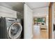 Laundry room features a modern washer and dryer with easy access to the living room at 10114 Meade Ct, Westminster, CO 80031