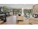 Bright living room with wood floors, fireplace, large windows, and access to the backyard at 10114 Meade Ct, Westminster, CO 80031